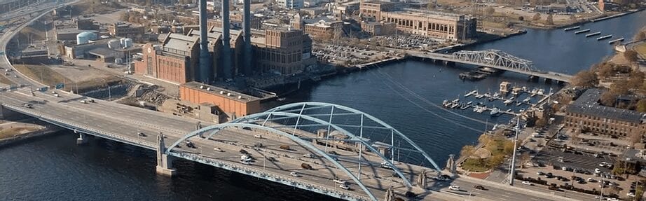 A bridge over water with buildings in the background.